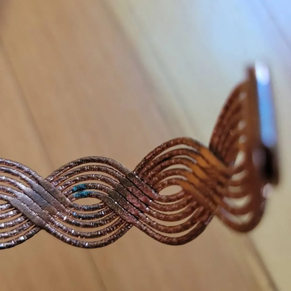Set of two bracelets copper colored wavy bangle and stretchy beaded multicolored